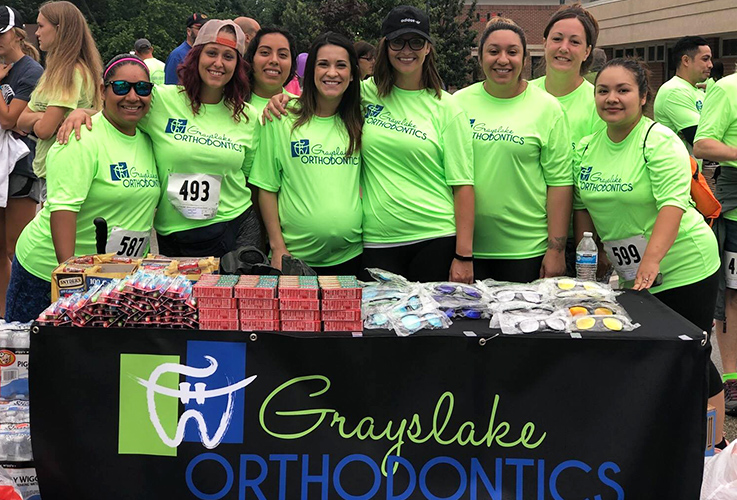 Orthodontic team members at information booth during Graylake five K