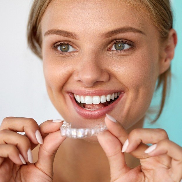 Woman placing clear aligner tray