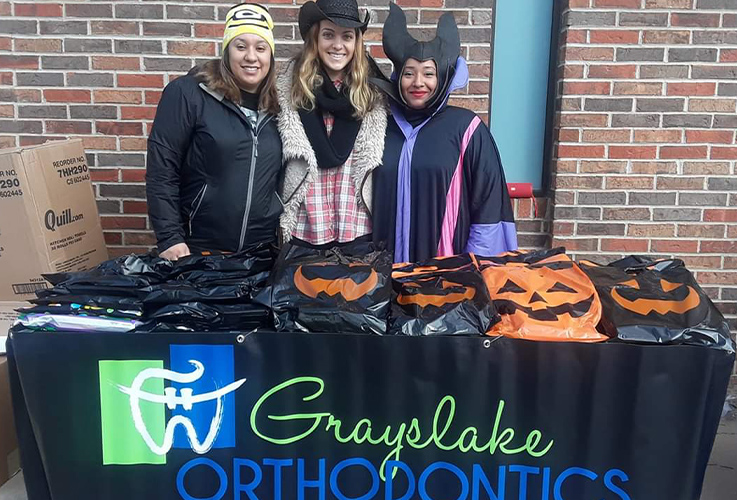 Three dental team members at Dowtown Grayslake trick or treat event