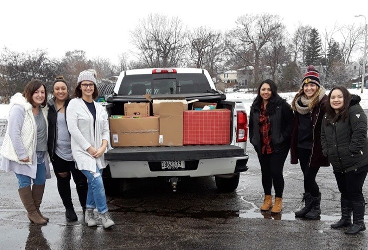 Team members delivering donations to the Avon Township food pantry