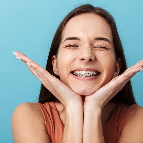 Young woman showing off smile during dentofacial orthopedics treatment