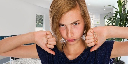 Young girl with headgear in pain frowning