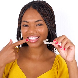 Happy young woman, glad she could afford Invisalign® treatment