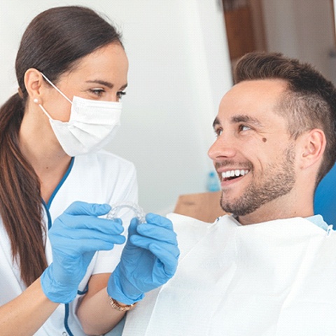 Orthodontic team member answering patient’s questions about Invisalign®