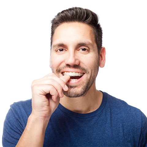 Man placing an Invisalign® tray