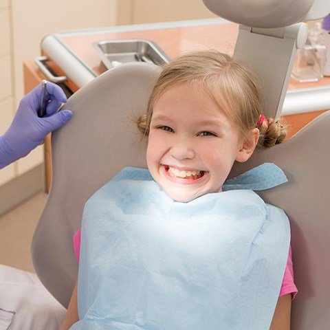 Little girl in orthodontic chair smiling