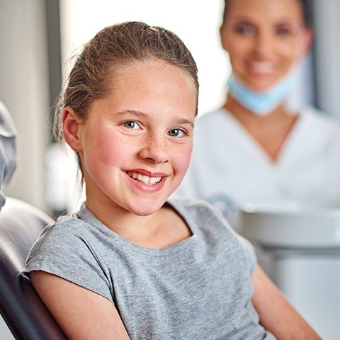 Little girl smiling in orthodontic chair during phase on orthodontics visit