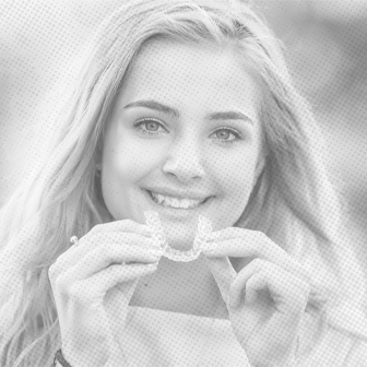 Woman placing clear aligners