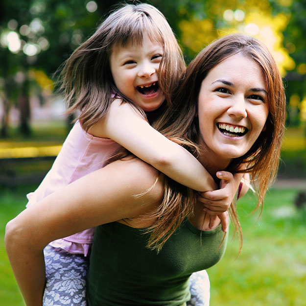 Mother and child laughing together after special needs orthodontics visit