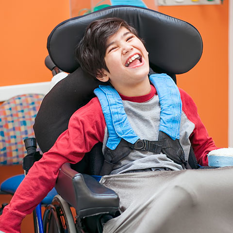 Laughing child in wheelchair