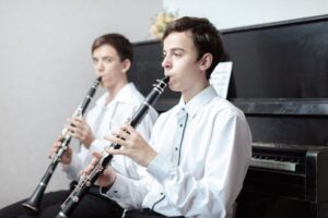 Two teen boys playing clarinets
