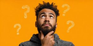 Question marks floating around curious man 